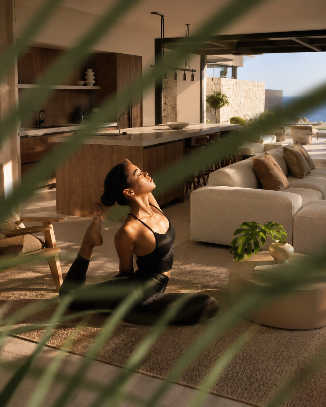 Woman doing yoga and self care in living room in Corales Villas, plants in front of her